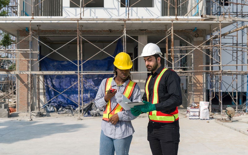 Two construction workers going over plans