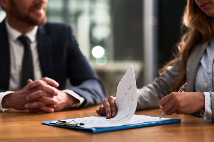 An attorney and client going over paperwork
